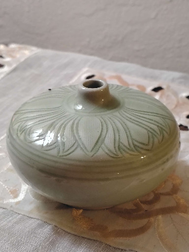 Celadon-glazed ceramic jar with carved lotus petal design