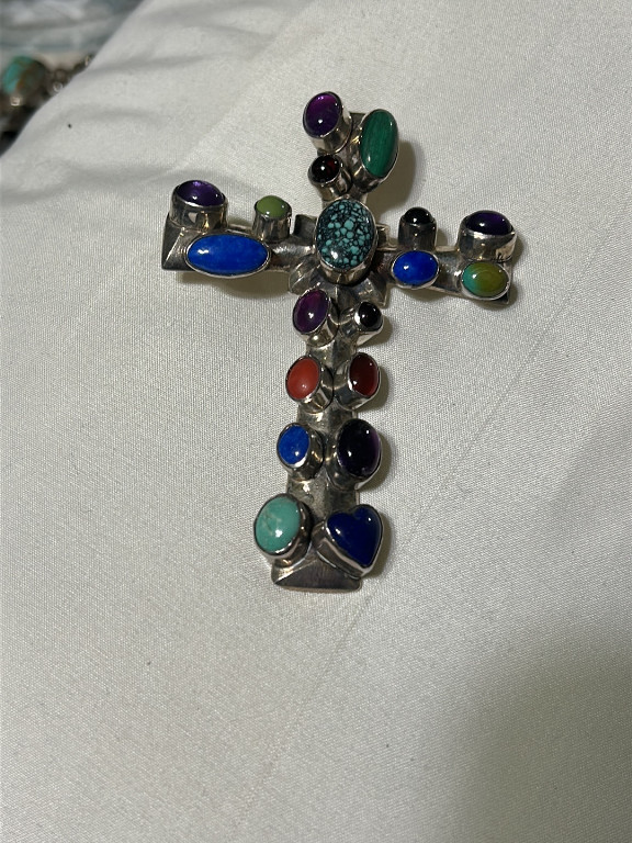 Sterling silver cross pendant with multiple gemstones including turquoise, lapis lazuli, amethyst, and coral