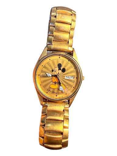 Gold-tone stainless steel quartz watch featuring Mickey Mouse on a starburst dial by Seiko