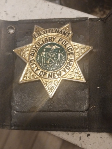 Metal badge titled 'Lieutenant Auxiliary Police City of New York'