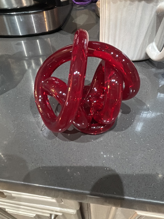 Hand-blown glass decorative knot sculpture in red