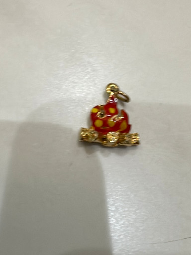 Gold-tone metal charm with red enamel depicting a snail