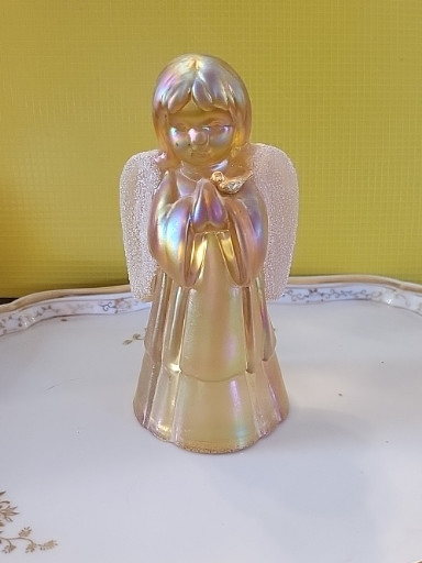 Carnival glass angel figurine with textured wings and gold bird by Fenton Art Glass