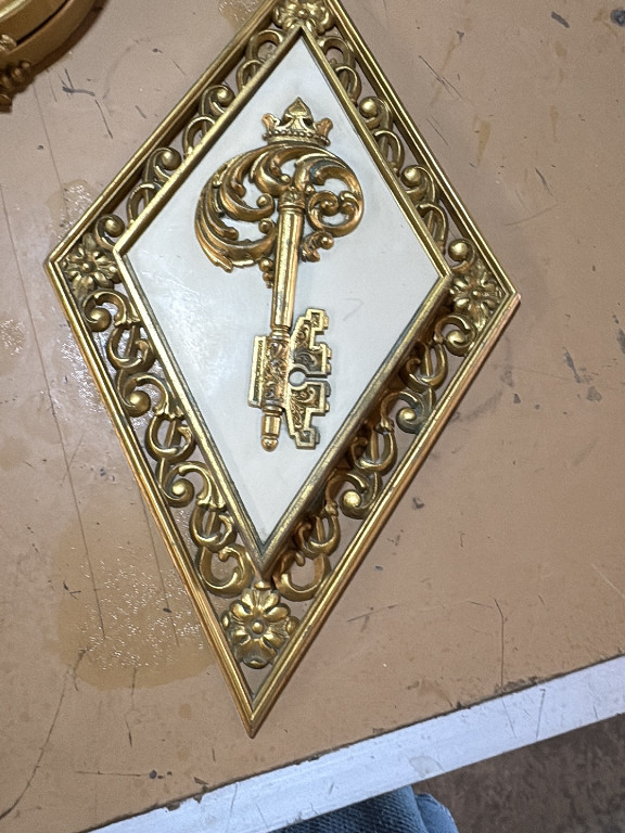 Plastic wall plaque featuring ornate key motif by Dart Industries