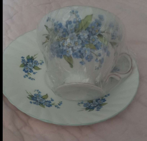 Fine bone china teacup and saucer with blue forget-me-not floral decoration