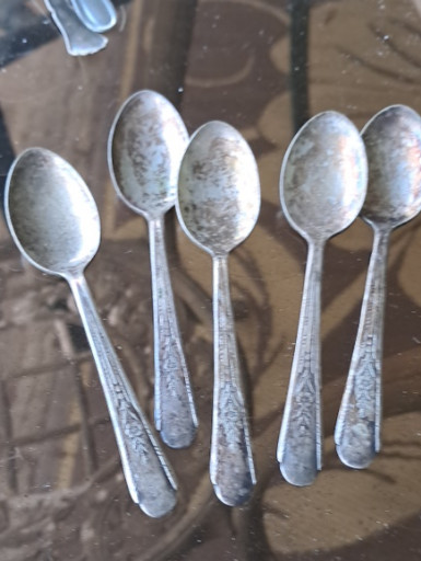 Set of five silver-plated teaspoons with ornate floral pattern handles