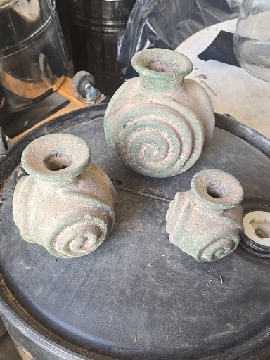Set of three ancient caliche pottery vessels with spiral relief decoration