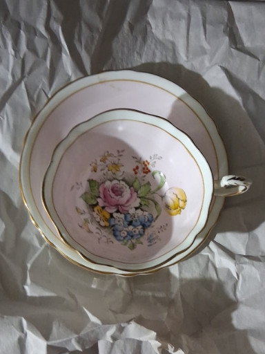Bone china teacup and saucer with floral decoration by Paragon