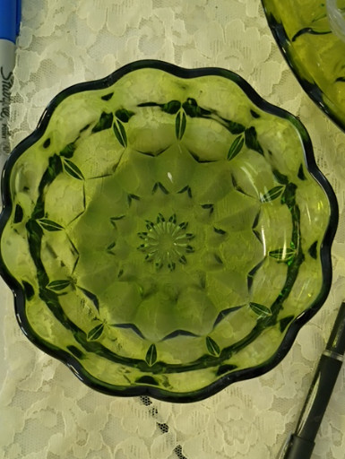 Pressed glass bowl in avocado green with scalloped rim and geometric pattern