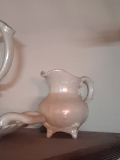 White ceramic pitcher with footed base