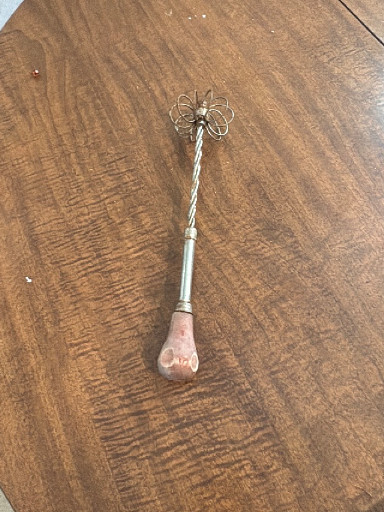 Vintage kitchen whisk with twisted wire handle and wooden grip