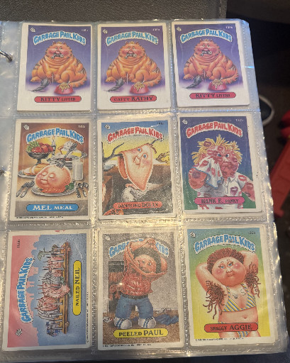 Collection of nine vintage Garbage Pail Kids trading cards from Topps, including characters like Wrinkled Rita, Mel Arae, Handy Randy, Peeled Paul, and Weird Archie