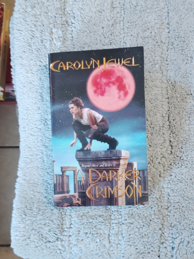 Paperback book titled 'A Darker Crimson' by Carolyn Jewel