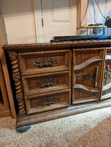 Oak dresser with carved details and ornate brass hardware, circa 1970s–1980s