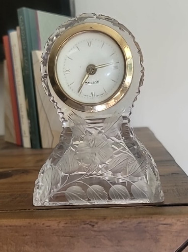 Crystal desk clock with decorative cut glass base and brass bezel, made in Germany
The clock doesn't work, it's a wind up. would need repaired or replaced.