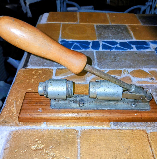 Reed's Rocket Nut Cracker Model R-300 with wooden handle and metal mechanism on oak base