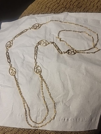 Vintage gold-tone chain necklace with decorative medallion stations, the letter cursive E,  sold by Avon