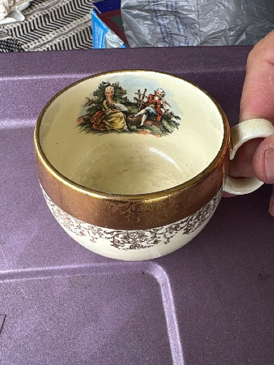 Porcelain teacup with saucer featuring courting couple scene, 'Crest-O-Gold' pattern by Sabin