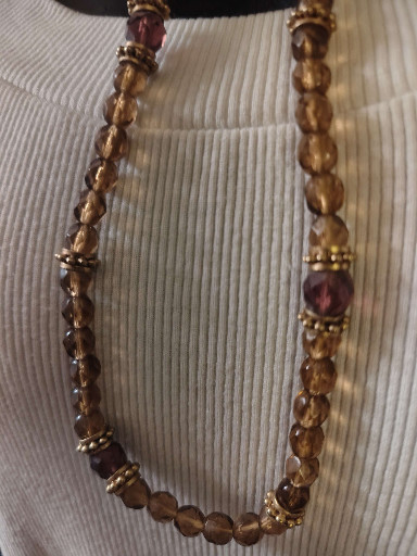Vintage costume jewelry necklace with amber-colored faceted glass beads and gold-tone metal accents
