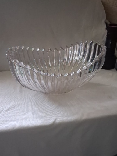 Clear pressed glass bowl in boat or canoe shape with ribbed design, likely by Sowerby