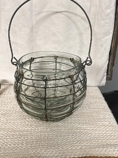 Glass jar in metal wire cage with handle