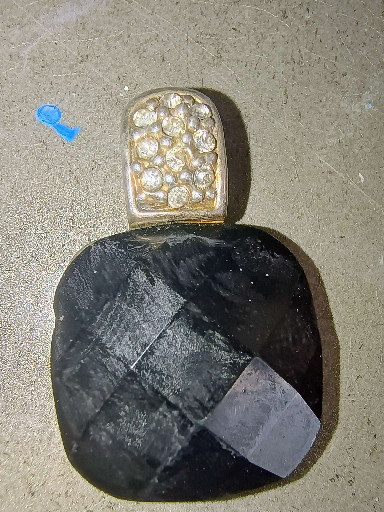 Gold and diamond pendant with faceted black onyx cushion-cut stone