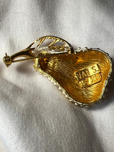 Gold-tone metal brooch in the shape of a pear with enamel detailing
