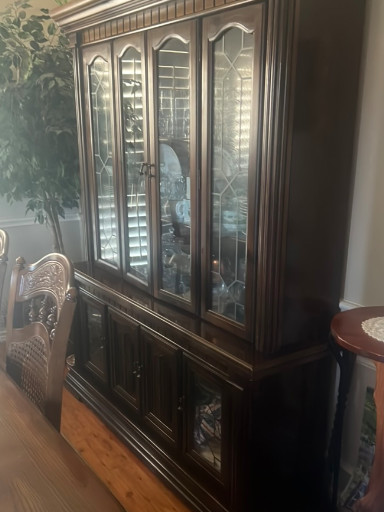 Dark wood china cabinet hutch with glass doors and mirrored back