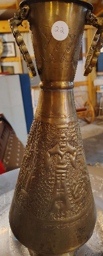Brass vase with repousse figural decoration and drop handles, Middle Eastern origin
