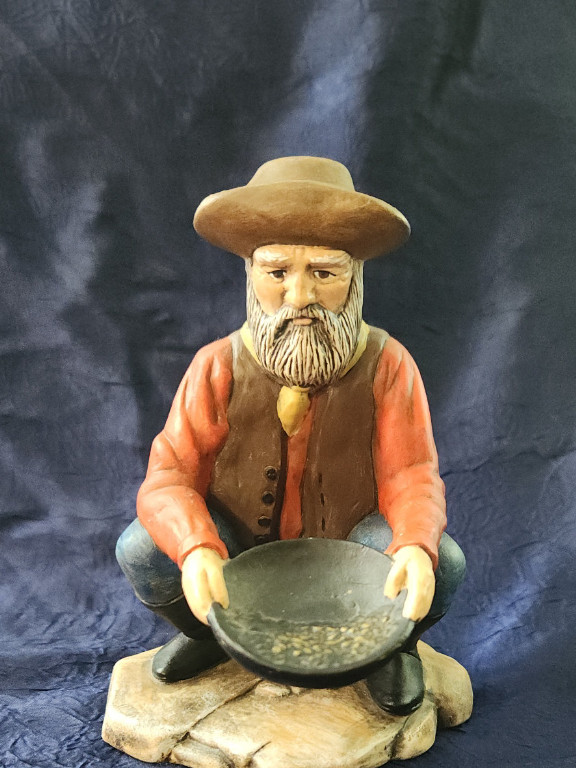 Ceramic figurine of a gold prospector with pan. Artist unk.