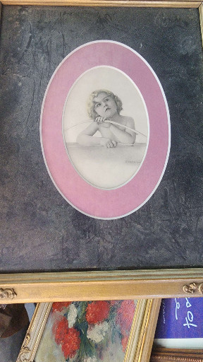 Vintage print of cherub or angel child in oval pink mat with wooden frame