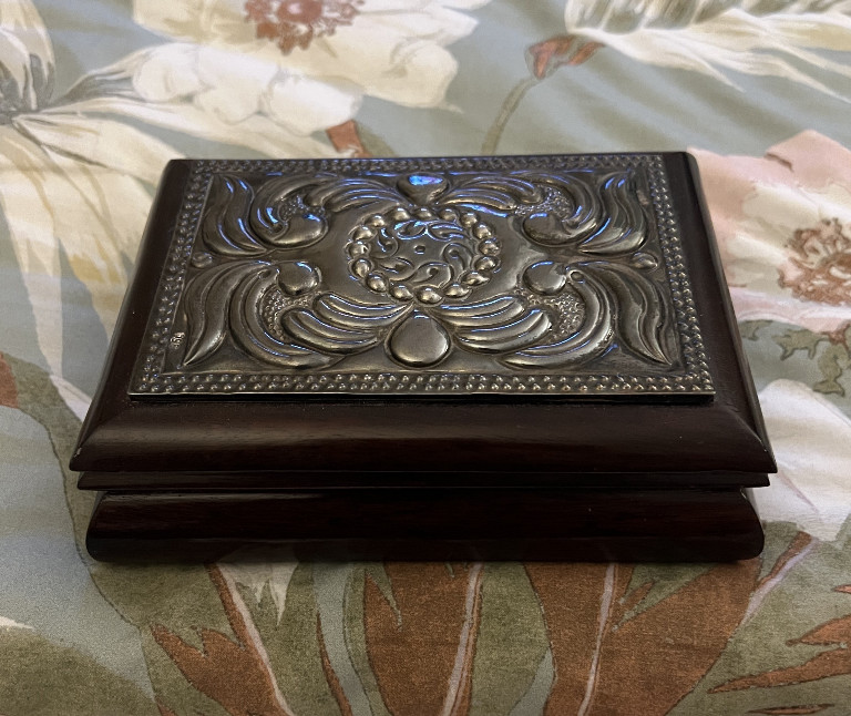 Wooden trinket box with sterling silver top featuring ornate floral and scroll design