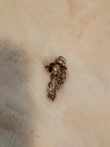 Gold-tone metal earring with rhinestone embellishments