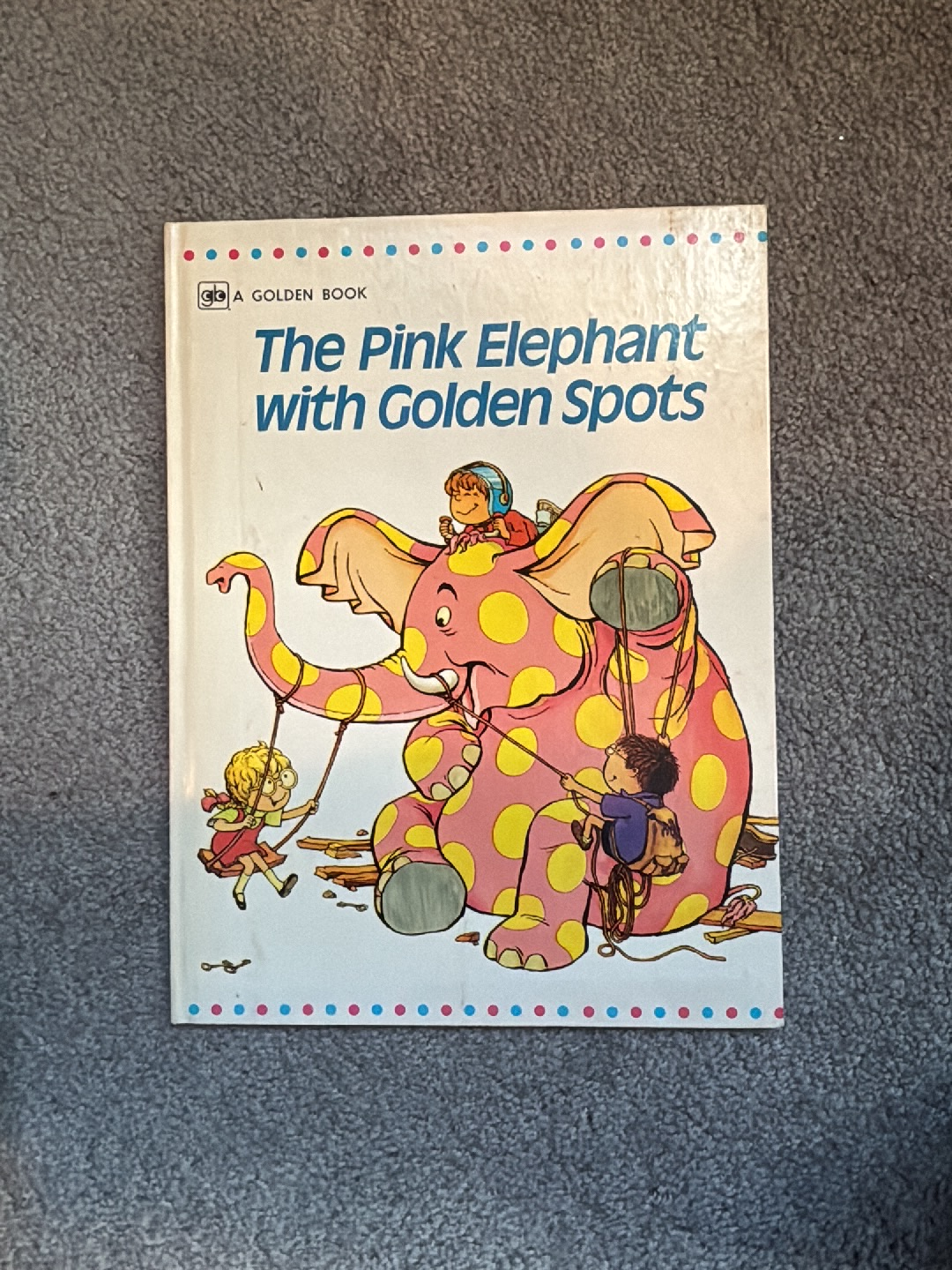 Children's book titled 'The Pink Elephant with Golden Spots' by Philippe and Réjane Fix