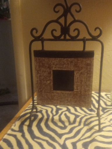 Wrought iron tabletop picture frame with decorative scrollwork