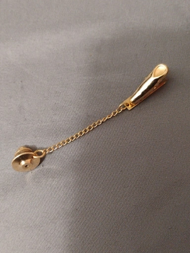 Gold-tone tie tack with decorative spoon-shaped end piece