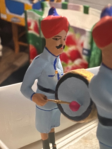 Hand-painted ceramic figurines depicting Indian ceremonial band musicians