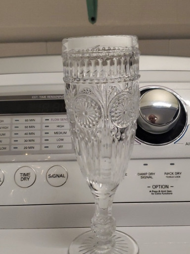 Pressed glass champagne flute with vintage-style decorative pattern