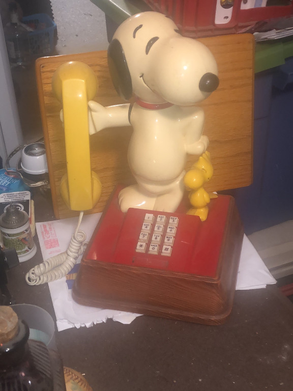 Vintage novelty telephone featuring Snoopy and Woodstock characters, manufactured by American Telecommunications Corporation