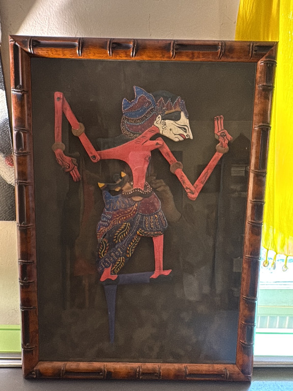 Javanese or Balinese Wayang Kulit shadow puppet in bamboo-style frame