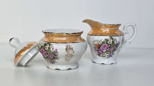 Porcelain creamer and sugar bowl set with floral decoration and gold luster trim, made in Japan