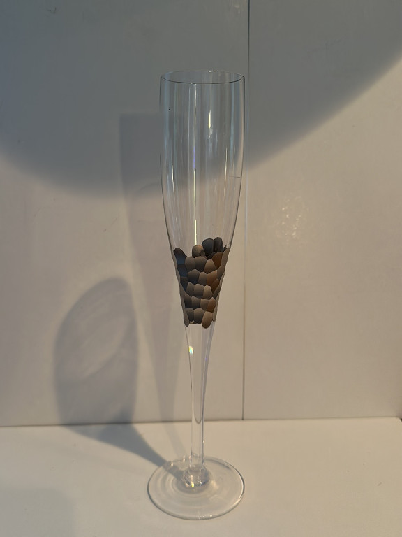 Glass champagne flute with decorative pebbles by Kim Seybert