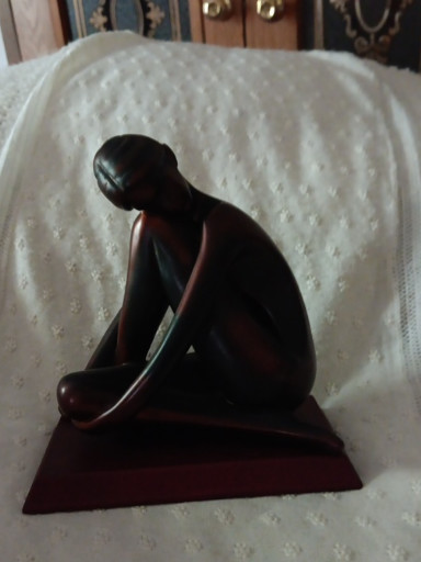 Carved wood sculpture titled 'Seated Ballerina' by Herco