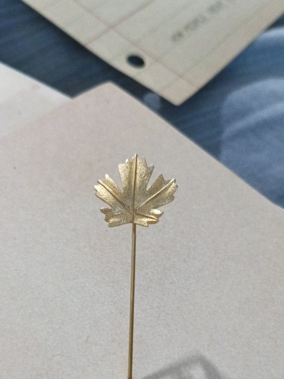 Gold tone maple leaf stick pin