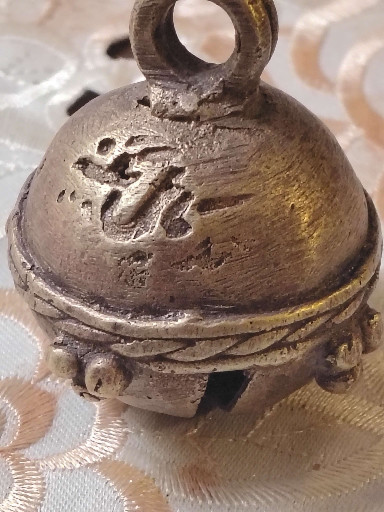 Bronze temple bell with hand-engraved deity motif