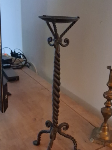 Wrought iron candle stand with twisted column and scrollwork base