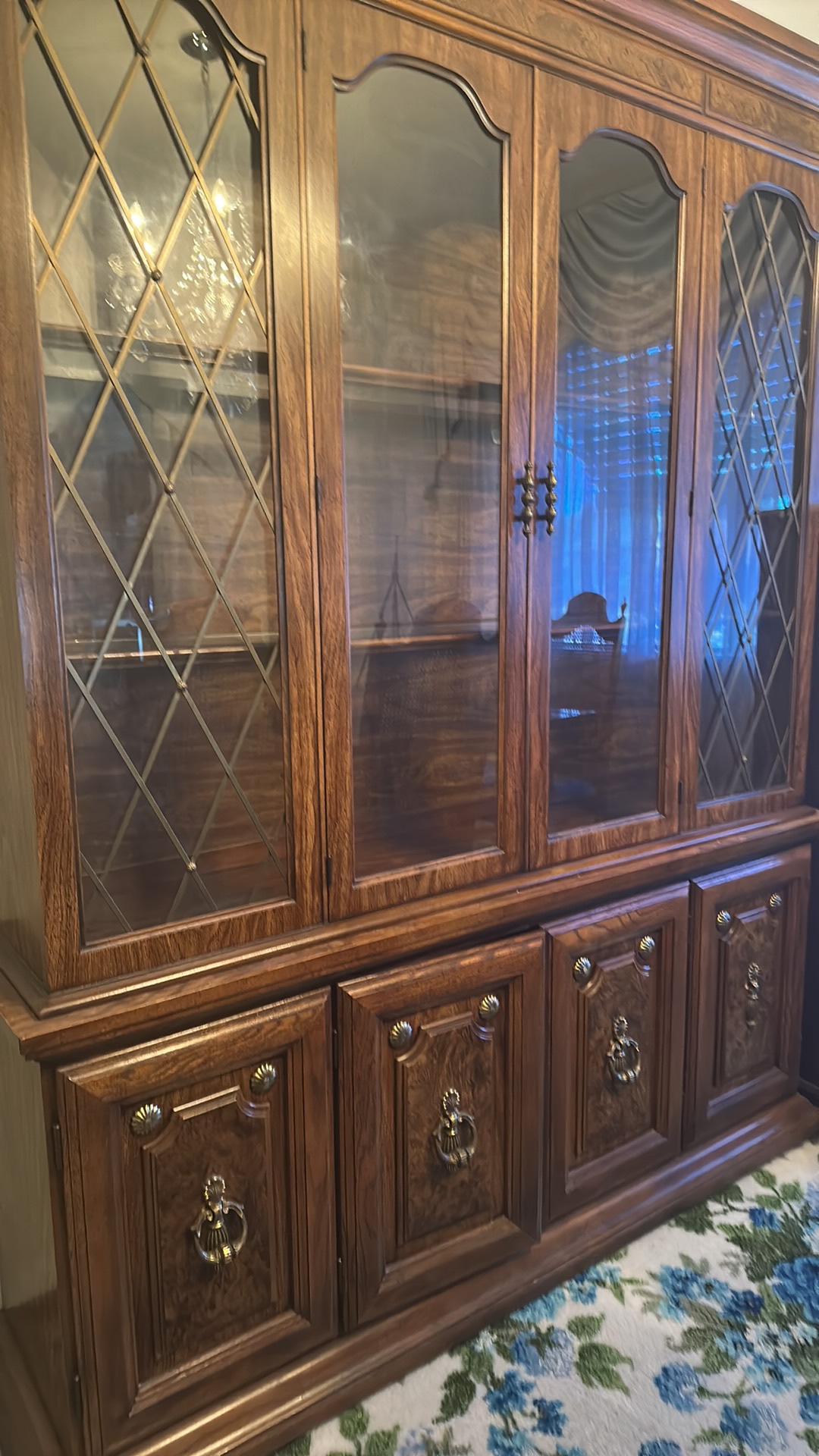Oak china cabinet with glass doors and brass hardware