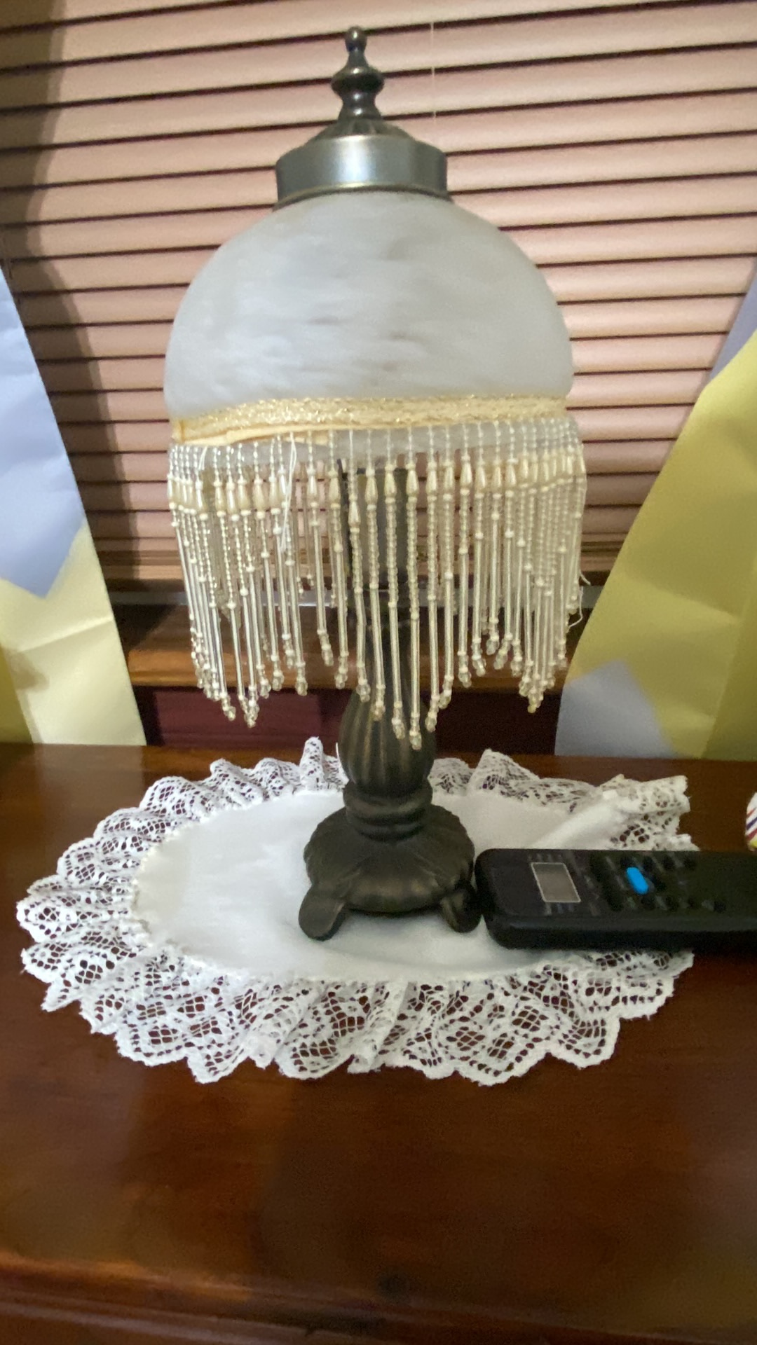 Metal table lamp with frosted glass shade and beaded fringe