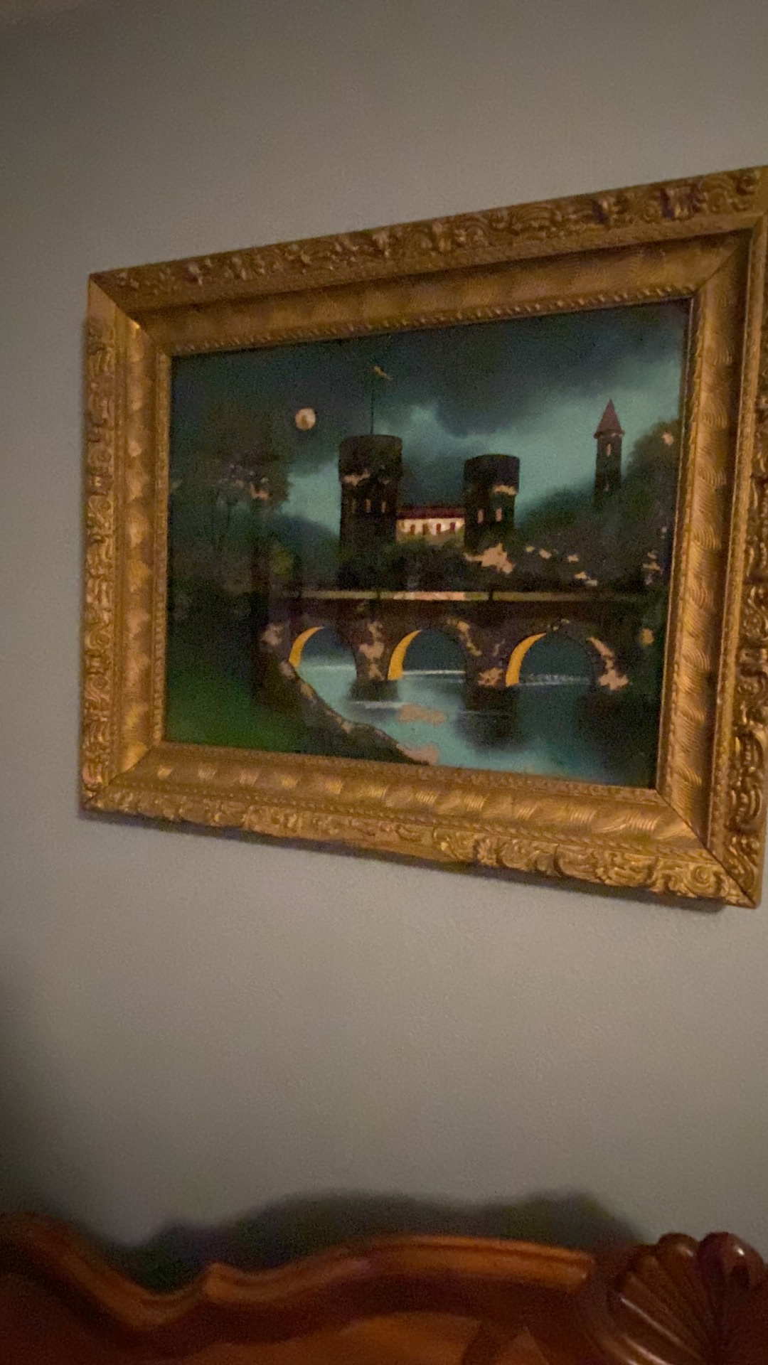 Oil painting titled "Nocturnal Castle Scene with Bridge" in ornate gilt frame