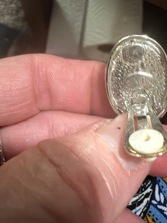 Silver tone filigree clip-on earring with decorative back